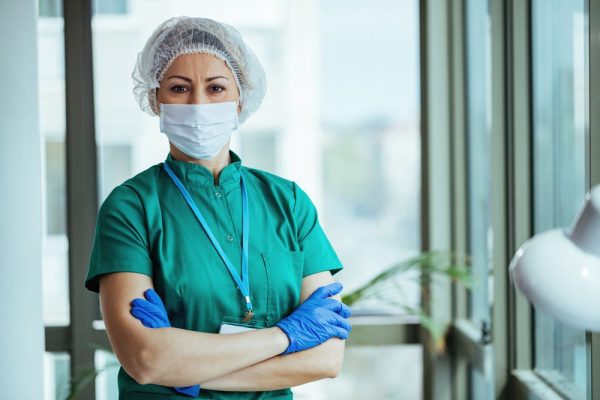 Portrait,Of,Surgeon,Standing,With,Her,Arms,Crossed,At,Medical