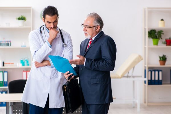 Male,Doctor,And,Businessman,Discussing,Medical,Project