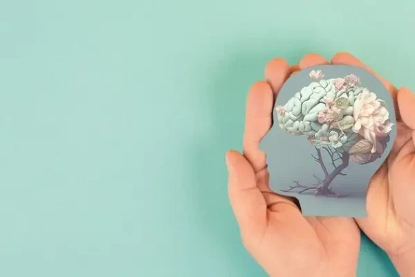 Hands,Holding,Paper,Head,,Human,Brain,With,Flowers,,Self,Care